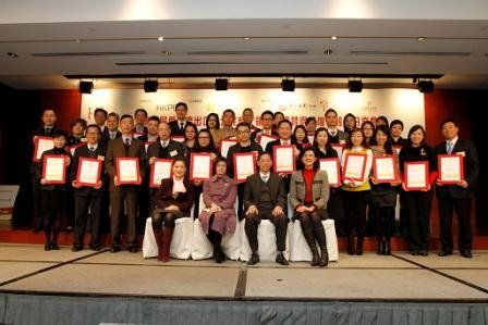 Officiating guests pose for a photo with the “Corporate Citizenship Logo” recipients