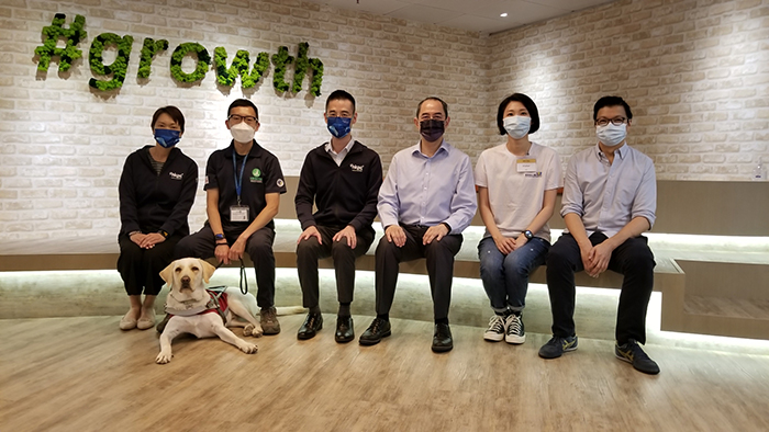 Mr Alex Chan, General Manager, Digital Transformation of HKPC (third from left); Mr Robert Wong, Founder of Geligulu.com (third from right); Mr Matthew Tam, Founder and CEO of Social Career Platform (first from right); Mr Kelvin Chan, Cadet Trainer of Hong Kong Seeing Eye Dog Services (second from left); Miss Oliva Chau, Project Manager of Life Commitment Charity Club (second from right); and Ms Irene Kan, Leading Consultant, Digital Transformation of HKPC (first from left) posed for a group photo at the “The Hong Kong Jockey Club IT Support Programme for NGOs” 1st anniversary and success case sharing seminar held on 27 May 2021.