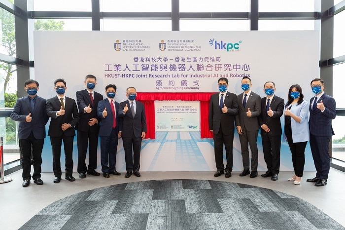 HKUST Vice-President for Research and Development Prof Tim Cheng (fifth left), HKUST (GZ) Vice-President for Graduate Support and HKUST CLP Holdings Professor of Sustainability Prof Charles Ng Wang-Wai (fourth left), HKPC Executive Director Mr Mohamed Butt (fifth right), HKPC Chief Digital Officer Mr Edmond Lai (fourth right), HKUST Otto Poon Professor of Engineering, Chair Professor from the Department of Computer Science and Engineering and Joint Lab Director Prof Zhou Xiaofang (third left), HKPC General Manager of Robotics and Artificial Intelligence Division and Joint Lab Co-Director Dr Ge Ming (third right), HKUST (GZ) Chair Professor and Acting Dean of Information Hub and Joint Lab Associate Director Prof Fugee Tsung (second left), HKUST Big Data Institute Director Prof Chen Lei (first left), HKPC Chief People and Culture Officer Ms Eliza Ng (second right), and HKPC Chief Marketing Officer Mr Henry Li (first right) unveil the plaque to commemorate the establishment of the Joint Lab.