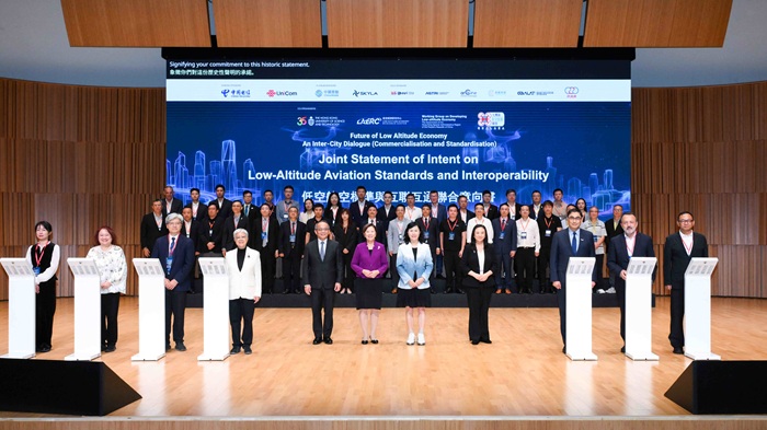 Witnessed by Ms Mable CHAN, JP, Secretary for Transport and Logistics of the HKSAR Government (centre, front row), Ms Elizabeth QUAT, SBS, JP, Legislative Council Member (fourth from right, front row), Mr Mohamed BUTT, MH, Executive Director of HKPC (third from right, front row), Professor Nancy IP, President of HKUST (sixth from left, front row) and Professor Tim CHENG, Vice-President of HKUST (fifth from left, front row), and Dr Winnie TANG, MH, JP, Vice President of the Greater Bay Area Low-Altitude Economy Alliance (fourth from left, front row), representatives of over 50 organisations  from industry, academia and professional organisations signed the “Joint Statement of Intent on Low-Altitude Aviation Standards and Interoperability”, jointly initiated by HKPC and the Greater Bay Area Low-Altitude Economy Alliance.